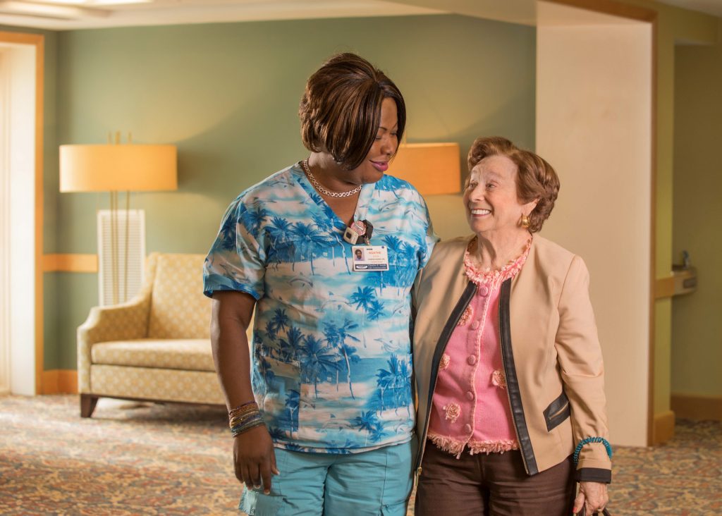 Elderly resident speaking with nurse