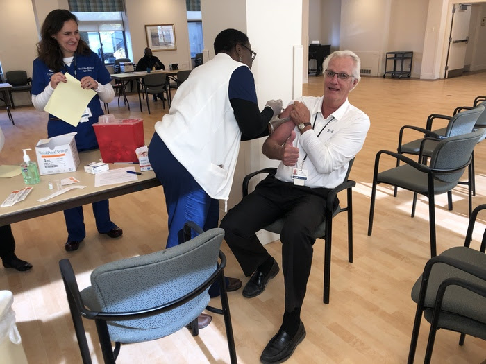 man in a nursing home facility receiving a flu shot