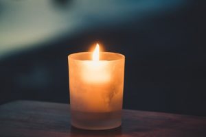 Lit candle at memorial service