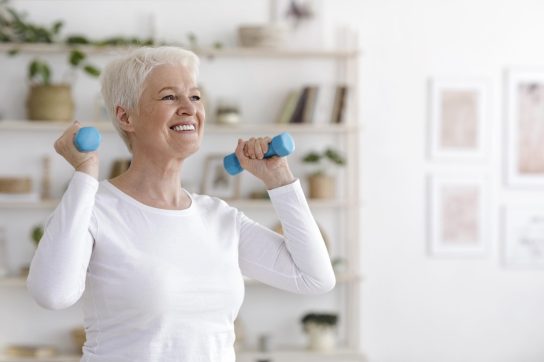 Senior woman working out with dumbells