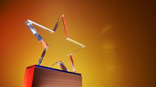 Close-up of star-shaped crystal award on a podium