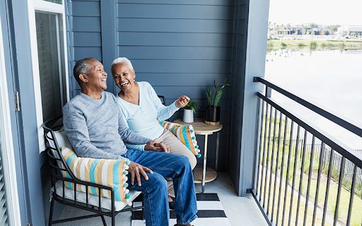 Older couple having coffee on their Charles E Smith patio