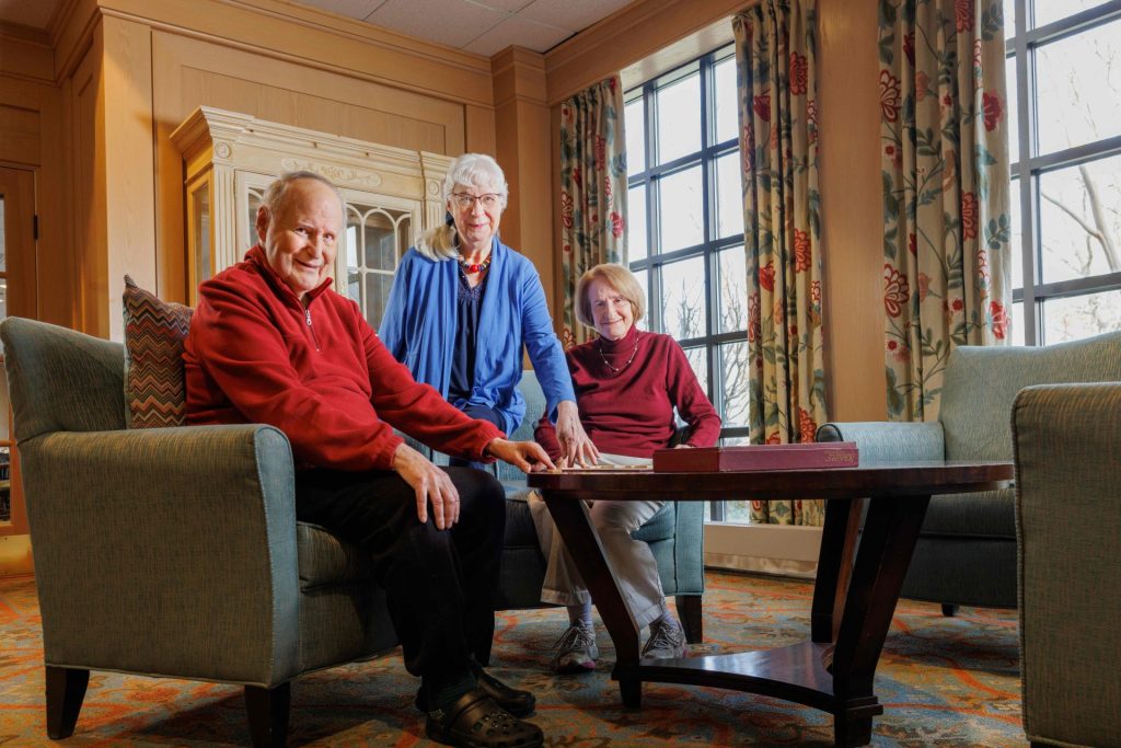 three seniors in living room for questions to ask when touring independent living communities
